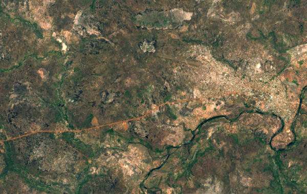 Satellite image of Banafassi in Senegal, showing a river winding across the area, and scrubland with brown and green patches, and a built up area